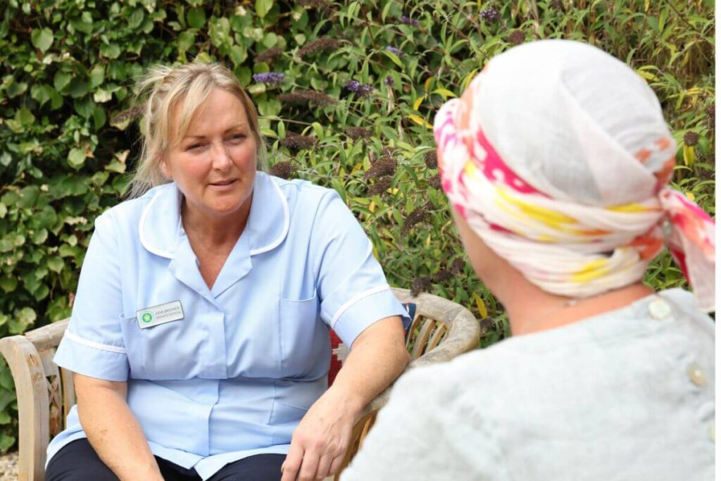 SHN nurse sitting in garden with patient
