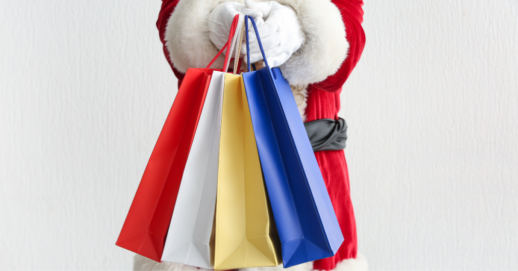 Santa holding shopping bags