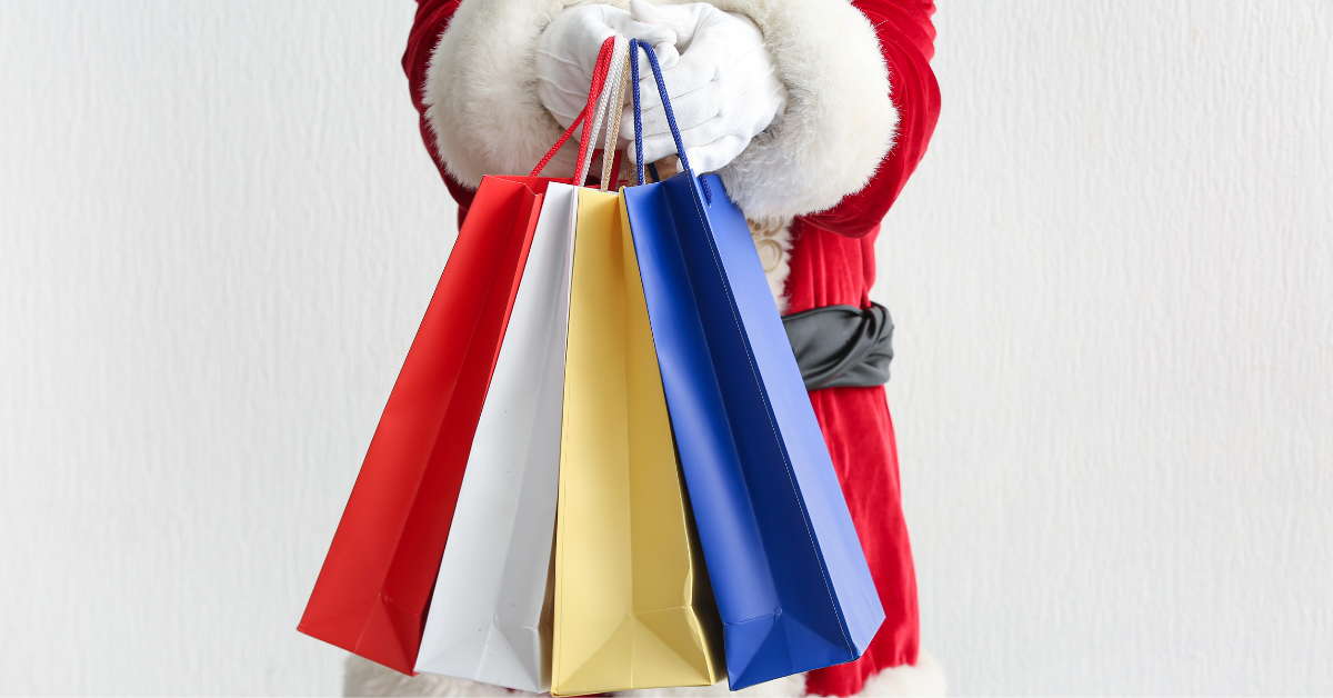 Santa holding shopping bags