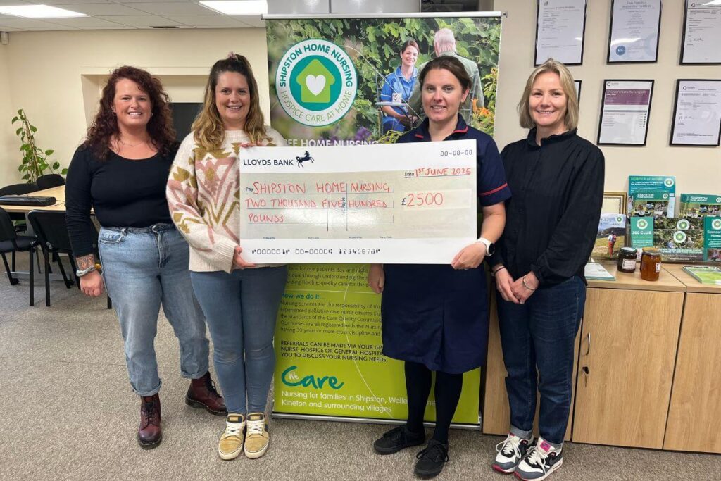 team at SHN holding cheque for money raised