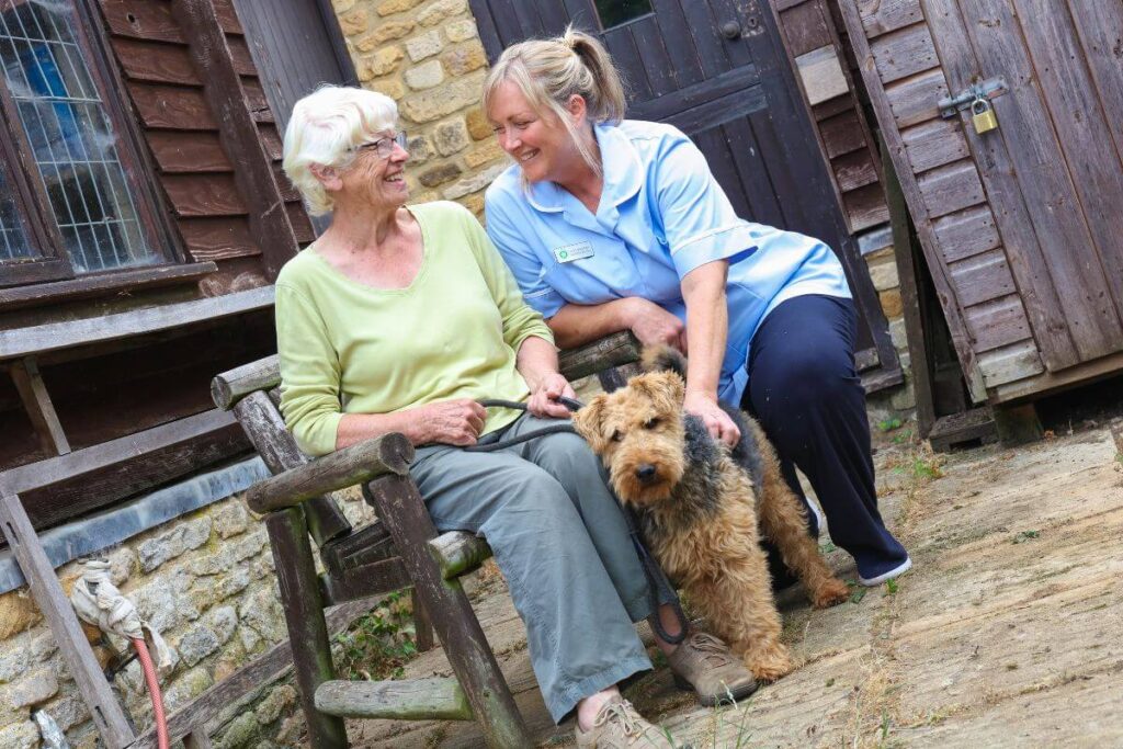 Shipson nurse with patient and her dog, smiling together