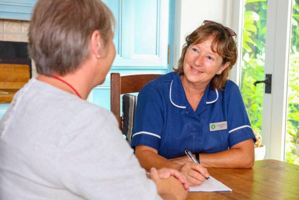 SHN nurse chatting with patient showing support